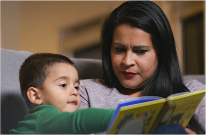 Mother reading a book to her son